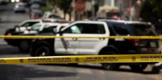 LA Mayor Orders Review of LAPD Tactics Police tape cordoning off street with patrol SUVs behind