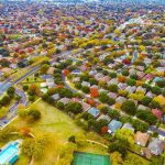 ‘Horseplay’ Ends in Fatal Tree-Work Accident Aerial view of suburban neighborhood with tree-lined streets in autumn