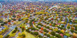 ‘Horseplay’ Ends in Fatal Tree-Work Accident Aerial view of suburban neighborhood with tree-lined streets in autumn