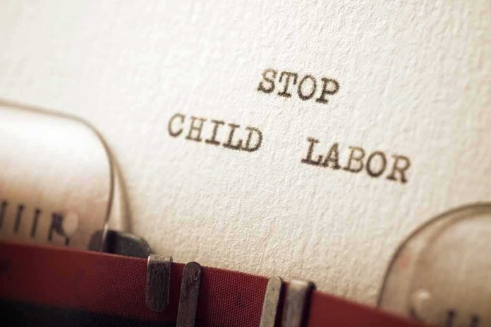 shutterstock_2074595140 Typewriter typing the words stop child labor