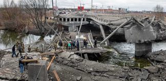 Hundreds Trapped: Nepal Tunnel Rescue People crossing a destroyed concrete bridge over a river