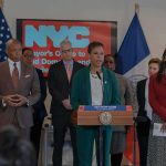 Millions Pour Into NY Governor Race Speaker at podium during a press conference with officials