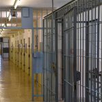 Ex-Deputy Convicted in Massey Killing Dies in Prison Prison corridor with barred doors