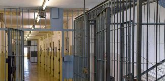 Prison corridor with barred doors