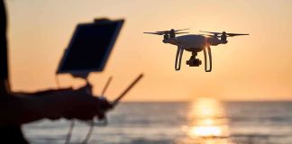 This Drone Didn’t Just Watch—It Gave Orders Drone hovering over beach at sunset