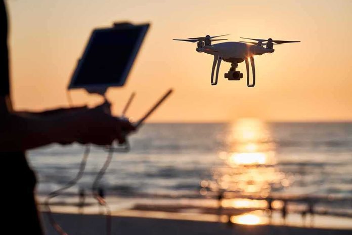 shutterstock_2322850857 Drone hovering over beach at sunset