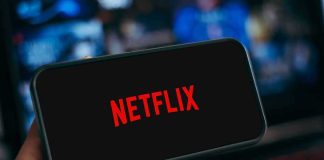 Fans Boil: GTA 6 Hits Netflix Before YouTube Smartphone displaying Netflix logo held in hand