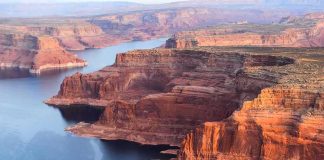 NYC Mom Slashed on Havasu Falls Trail Red sandstone cliffs by a winding blue lake
