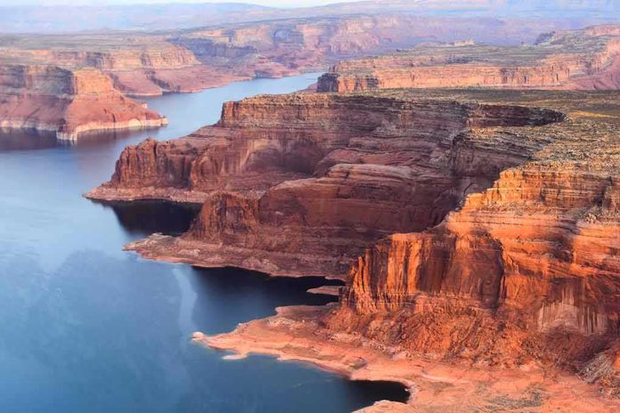 shutterstock_322874654 Red sandstone cliffs by a winding blue lake