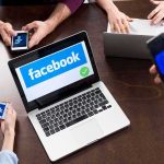 Meta Hit With $375M Penalty Over Child Safety Laptop with Facebook on screen surrounded by smartphones