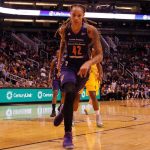 Bizarre Court Chaos: Fans Disrupt WNBA Games basketball player dribbling on a court during a game