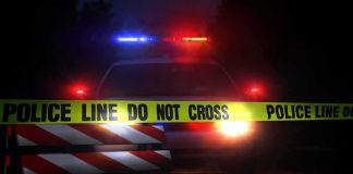 Swiss Rave Shooting Leaves One Dead, Five Wounded Police car behind crime scene tape at night