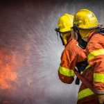Big Sur Wildfire Explodes to 1,300 Acres Firefighters spraying water on a blaze