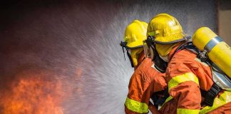 Big Sur Wildfire Explodes to 1,300 Acres Firefighters spraying water on a blaze