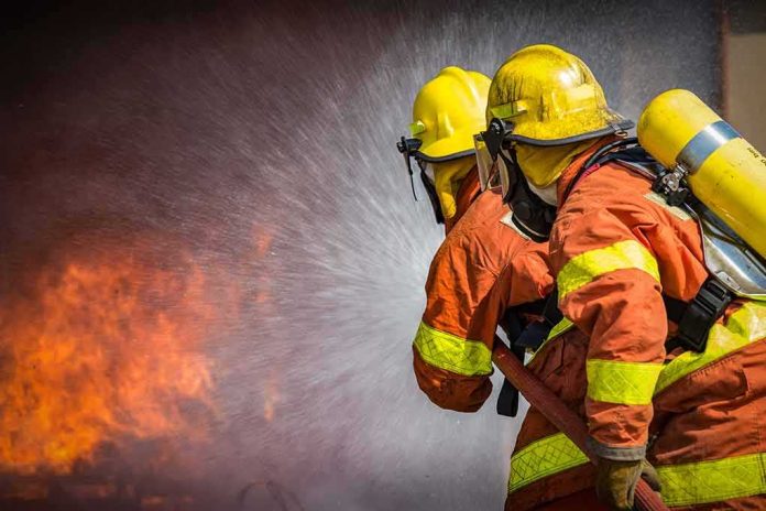 shutterstock_734297302 Firefighters spraying water on a blaze