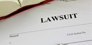 Backyard Game: Maine Family Files Wrongful-Death Lawsuit document with a pen and book.