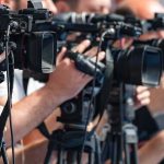 The Beer Pour Everyone Mocked television cameras on tripods at a media event