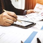 SpaceX Targets Historic IPO With Trillion-Dollar Buzz Businessperson analyzing charts with tablet and papers