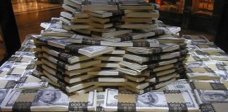 $3 Million Hidden Across 19 Accounts Stacks of U.S. hundred-dollar bills arranged in a pyramid