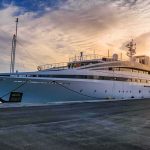Superyacht Arrives in Los Angeles With Its Name Covered Large luxury yacht moored at a marina at sunset