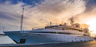 Large luxury yacht moored at a marina at sunset
