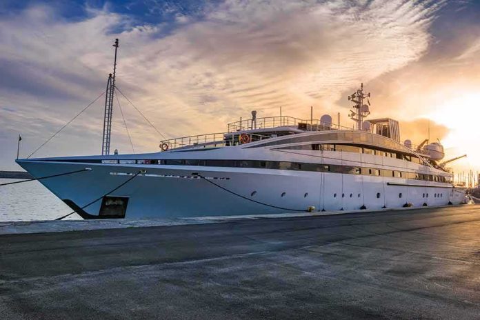 Large luxury yacht moored at a marina at sunset