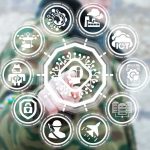 Private Biometric ID Firms Are Expanding Faster Than the Laws Person in camouflage touches virtual interface with cybersecurity and technology icons