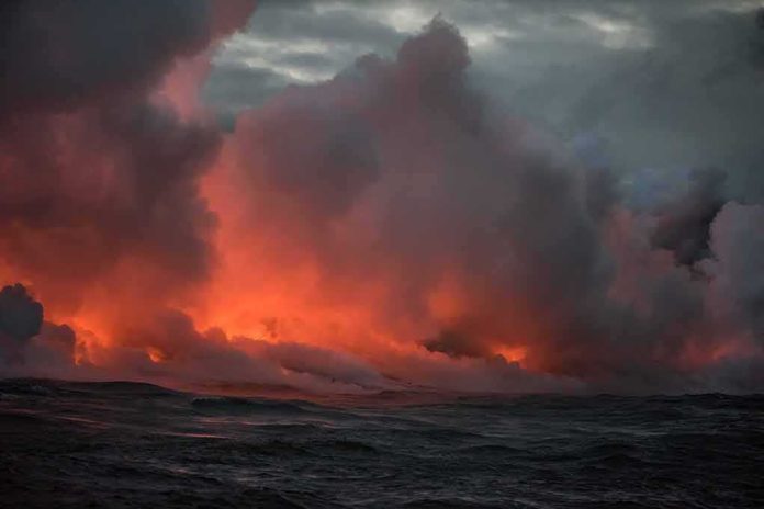 shutterstock_1120580558 Volcanic steam plume over dark ocean at dusk