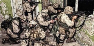 U.S. Troops Killed in Kuwait Strike soldiers in camouflage gear take positions inside a damaged building