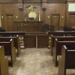 Texas Father Vows to Block Killer’s Release Forever Interior view of an empty courtroom with wooden benches and a judges bench