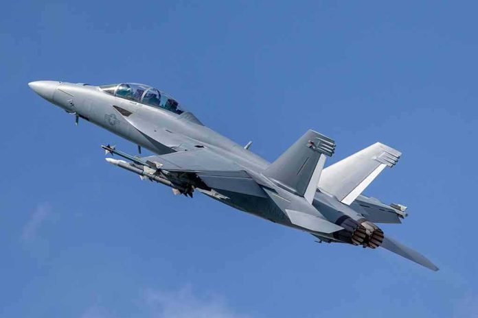 shutterstock_1258413700-1 Twin-engine fighter jet climbing in a clear blue sky