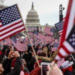 Trump’s July 4 Speech Divides America Crowd waving American flags near the U.S. Capitol