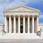 Court’s Immunity Ruling Adds Complexity to Questions Front view of the Supreme Court building with large columns and steps under a blue sky