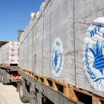 Humanitarian aid trucks loaded with palletized supplies