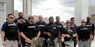 Group of law enforcement officers with tactical gear and a K9