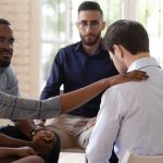 support group comforting a man