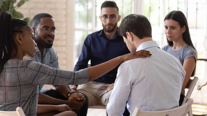 support group comforting a man