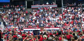 Trump Takes Center Stage at Historic Convention Crowd at a political rally facing a podium