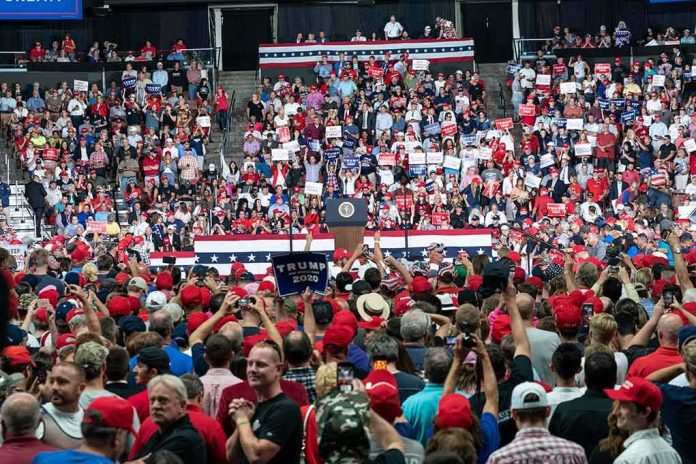 Crowd at a political rally facing a podium