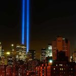 New York City skyline at night with twin blue light beams