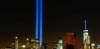 New York City skyline at night with twin blue light beams
