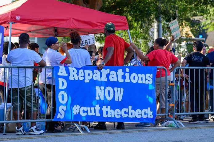Protesters behind barricades holding a blue reparations banner