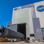 NASA Launches Roman Telescope Ahead of Schedule Rocket stage moved on transporter outside large NASA assembly building