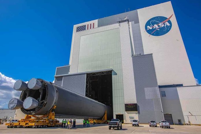 shutterstock_1521722225 Rocket stage moved on transporter outside large NASA assembly building
