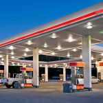 gas station canopy with multiple fuel pumps at dusk