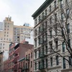 Deadly Heat Wave Claims at Least 19 Lives in New Jersey Street view of urban apartment buildings with fire escapes