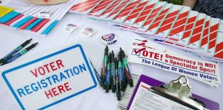 DSA Gains Ground Inside Democratic Party Voter registration table with forms, pens, and informational materials