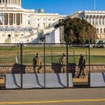 July 4 Event Descends: Chaos After Storms Force Evacuation Soldiers stand behind a security fence near a large government building