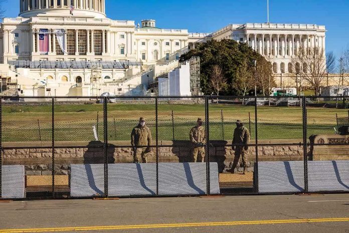 shutterstock_1890332989 Soldiers stand behind a security fence near a large government building