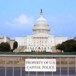 Verified Investments, Unverified Mansion Claims View of the U.S. Capitol building with a security barrier in front